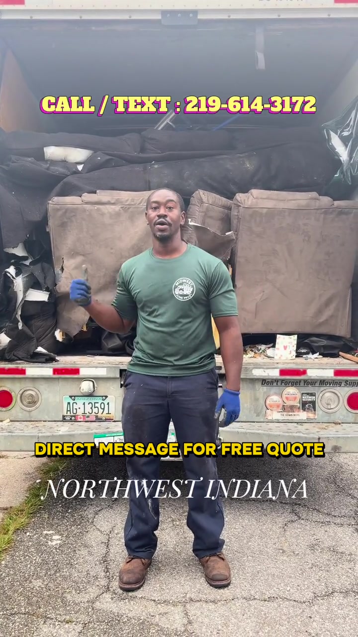 Midwest Junk Pros owner beside a loaded removal truck — On the job